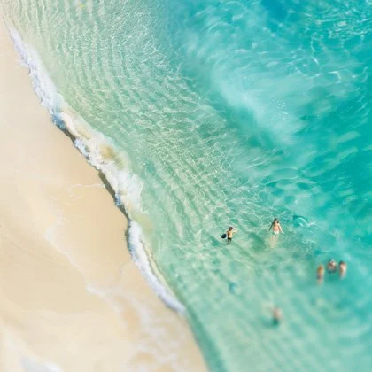 Toy people at beach, top-down view